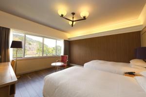Letto o letti in una camera di Kawana Hotel