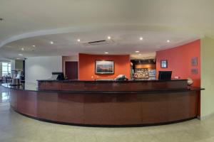 a large lobby with a bar in a hospital at Courtyard by Marriott Jacksonville Beach Oceanfront in Jacksonville Beach