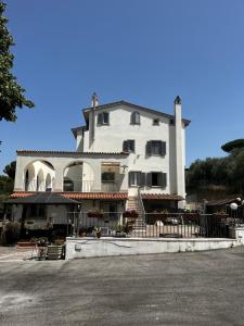 a large white building with a balcony on a street at Villa Wuthering Heights in Rome