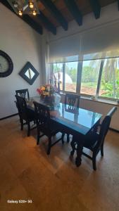 a dining room with a table and chairs and a clock at marina vallarta, One bedroom condo in Puerto Vallarta