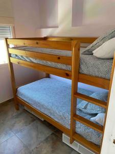 a set of bunk beds in a room at Pequeño estudio ubicado en plena Sierra de Espadán 