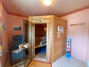 a room with a large wooden closet in a room at Ferienhaus SOL - in Staphel