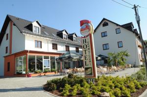 a hotel with a sign in front of a building at Beierleins Hotel & Catering GMBH in Reichenbach