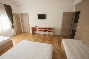 a room with a bed, chair, and table in it at Sweet Dreams Rooms and Apartments Postojna in Postojna