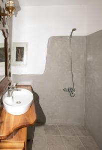 a bathroom with a sink and a shower at Messes Traditional Stone House with Amazing Sea View in Mandrakion