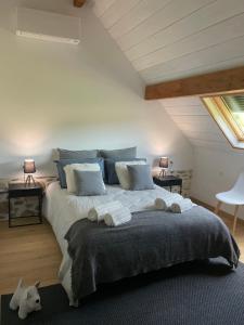 a bedroom with a large bed with blue pillows at Domaine des pierres trouvées in Saint-Vincent