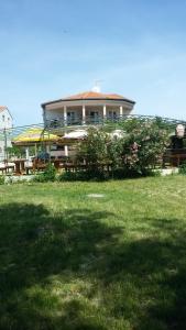 a large building with a grass field in front of it at Apartments Blanca in Vodice