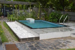 a swimming pool with a swing in a garden at VSP's Villa - Kensville Golf Living in Nānodra