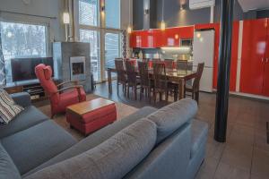 a living room with a couch and a dining room at Hyvärilä Youth- and Holiday Centre in Nurmes