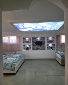 a room with two beds and a tv on a ceiling at YİRMİ İKİ in Edirne