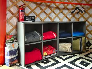 a room with a shelf with different colored pillows at Jurte in Bayern – spirituelle Reise ins Keltenland in Neuburg an der Donau