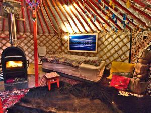 Una habitación con cama y chimenea en una yurta en Jurte in Bayern – spirituelle Reise ins Keltenland, en Neuburg an der Donau