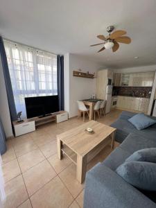 a living room with a couch and a table at Apartamento Soña Club Tenerife Los Cristianos in Los Cristianos