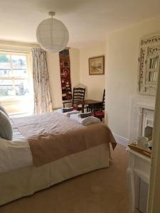 a bedroom with a bed and a window and a table at Home from home in Linton in Linton