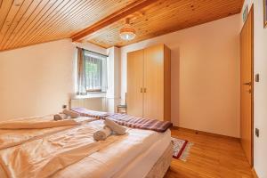 a large bed in a room with a wooden ceiling at House Mavko Near Lake Cerknica - Happy Rentals in Grahovo