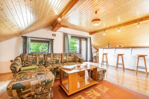 a living room with a couch and a table at House Mavko Near Lake Cerknica - Happy Rentals in Grahovo