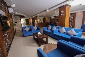 a living room with blue couches and a table at Lina Park 2 in Dammam