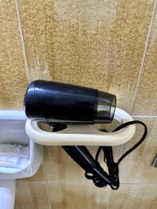 a hair dryer sitting on the side of a toilet at Casa Vittorio in Turin