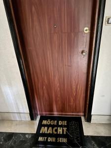 a sign in front of a wooden door at Casa Vittorio in Turin