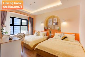 a hotel room with two beds and a window at FLC Quy Nhơn Sea Tower - View Biển Beach Emerald in Quy Nhon +258 photos