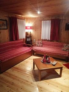 a room with two beds and a table in it at Traditional Wooden Apartment in Koutsodímos