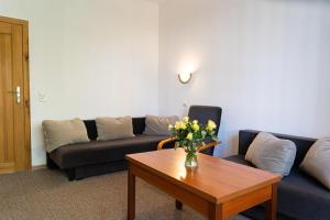 a living room with a couch and a coffee table at Dom Wczasowy Elsta Vita in Władysławowo