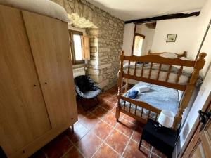 a bedroom with two bunk beds in a room at Caserío `The Formicary´ in Antezana de la Ribera