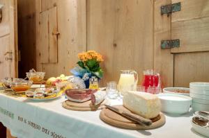 a table with a white table cloth with food on it at B&B Il Sorriso Dei Nonni in Pracorno di Rabbi
