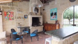 a living room with a fireplace and a table and chairs at La Chapelle du Domaine de Choisy in Abzac