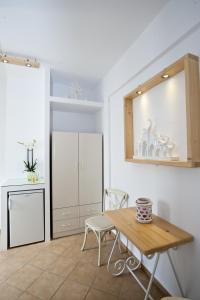 a dining room with a table and a mirror at Yanna Asteri Suites in Ornos
