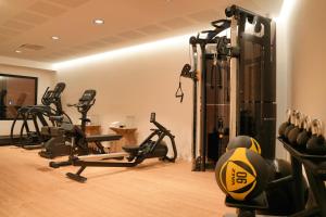 a gym with several tread machines in a room at Les Regalia Hôtel & Spa in Sainte-Lucie de Porto-Vecchio