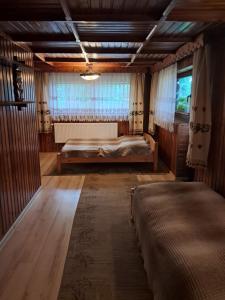 a bedroom with two beds and a large window at Willa Marianna in Zakopane