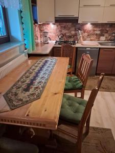 a kitchen with a wooden table and two chairs at Willa Marianna in Zakopane
