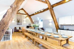 a large dining room with a long wooden table at Cruck'd Barn in Buxton