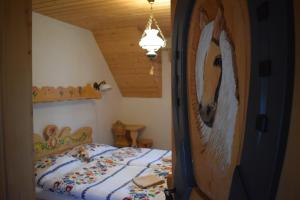 a bedroom with a bed and a wooden ceiling at Penzión na gazdovskom dvore in Dolný Kubín