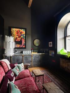 a living room with a couch and a table at Alpine Apartments Snowdonia in Betws-y-coed