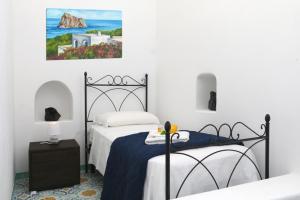a bedroom with two beds and a painting on the wall at Hotel Da Franco Relax and Pool in Santa Marina Salina