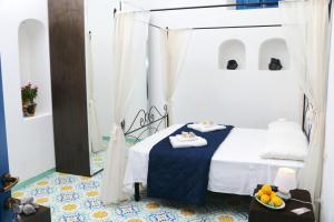 a bedroom with a bed with a blue and white comforter at Hotel Da Franco Relax and Pool in Santa Marina Salina