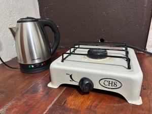 a toaster sitting on a wooden floor next to a kettle at Depto Villa Unión I in Villa Unión