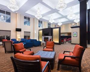 a lobby with a waiting room with chairs and a tv at Comfort Suites DuBois in DuBois