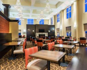 a restaurant with tables and chairs and a fireplace at Tannery Suites in DuBois