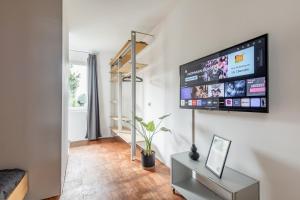 a living room with a flat screen tv on a wall at Luxus Loft I Wi-Fi I Gasgrill I Feldmarksee I 3 Schlafzimmer in Sassenberg