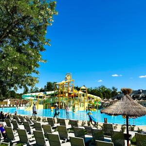 a pool with a water park with a roller coaster at Julinek CAMP in Leszno