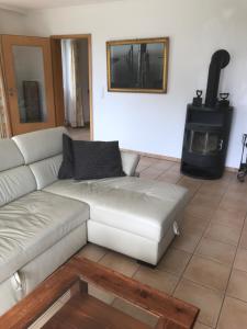 a living room with a white couch and a stove at Apartment "Suites" Biermann in Garding
