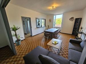a living room with a couch and a table at LE GITE LA BLAQUERE Bis in Cendras