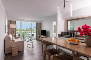 a living room with a dining room table and a living room at Amara Cay Resort in Islamorada