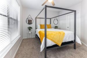a bedroom with a canopy bed with a yellow blanket at NRG Stadium, the Medical Center Bright and Cozy Unit in Houston +21 photos