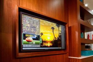 a flat screen television in a wooden wall at Courtyard by Marriott Orlando Lake Nona in Orlando