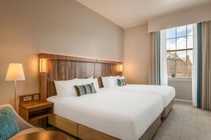 a hotel room with a large bed and a window at Courtyard by Marriott Edinburgh in Edinburgh