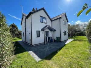 a house with a large yard in front of it at The Farmhouse at Moss Bank Farm in Wrexham